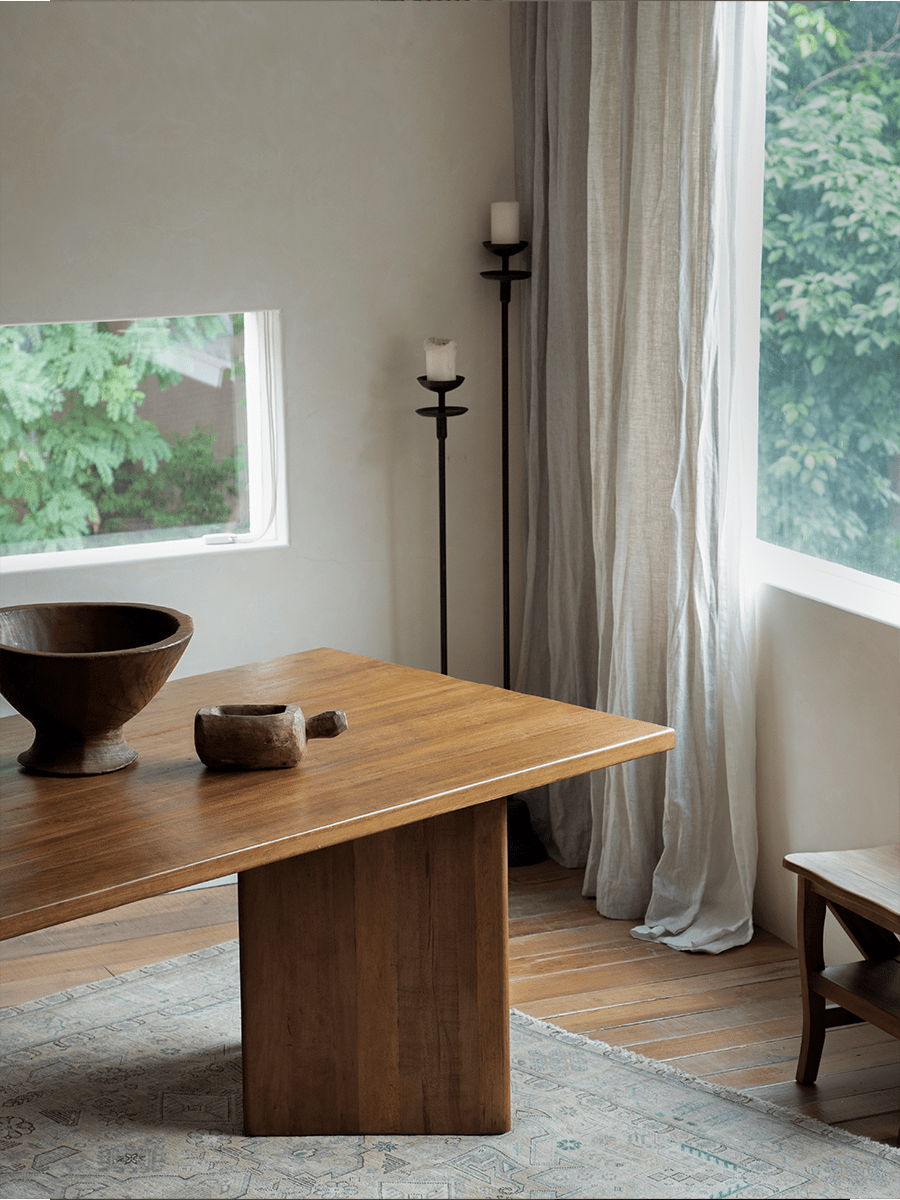 Zephyr Dining Table with a solid leg and natural wood, perfect for dining in a bright room.
