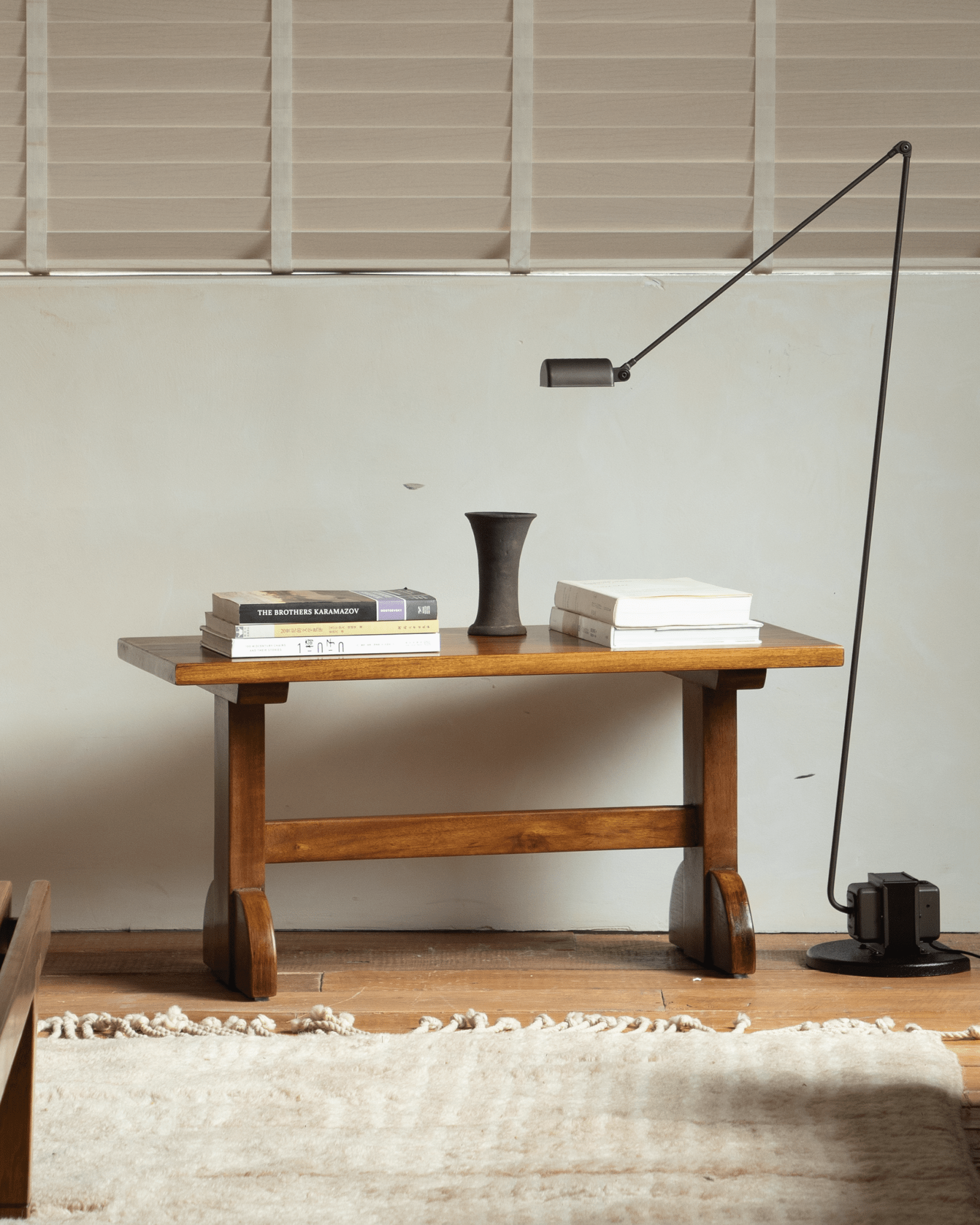 Hoof Side Table styled with books and modern lamp in warm setting.