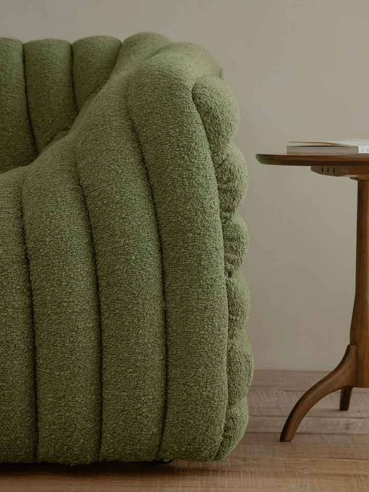 Close-up of green Miche Sofa showcasing its textured fabric and rounded design.