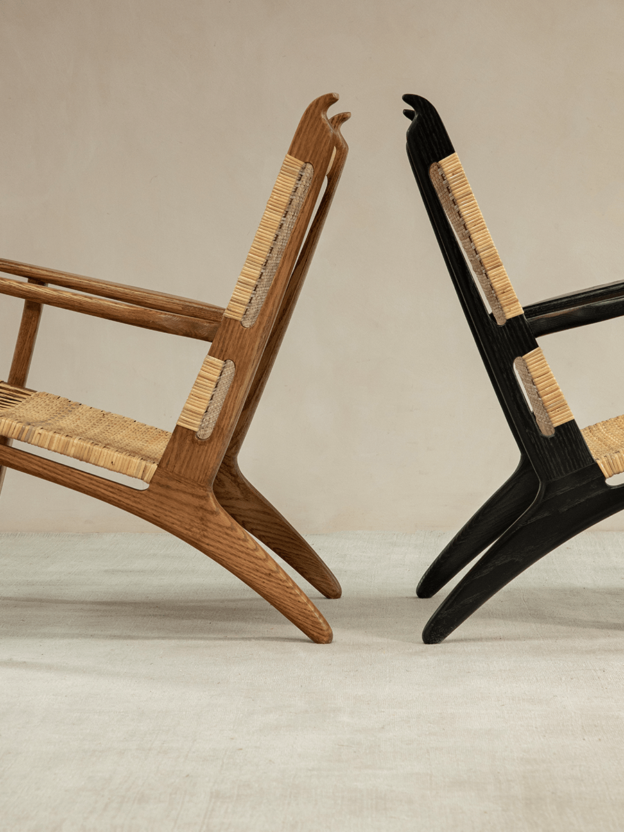 Horn Lounge Chair in wood and black, featuring oak frame, natural rattan seat, ergonomic design.