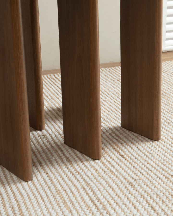 Close-up of Titan teak dining table legs showcasing sturdy multi-leg design.