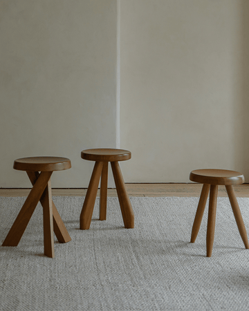 Set of three solid wood French stools with natural wood finish, perfect for versatile seating.