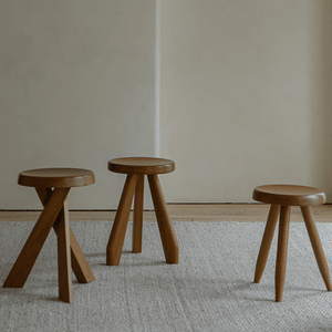 Set of three solid wood French stools with natural wood finish, perfect for versatile seating.