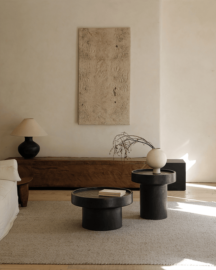 Modern black Stamp Coffee Tables with minimalist decor in a stylish living room.