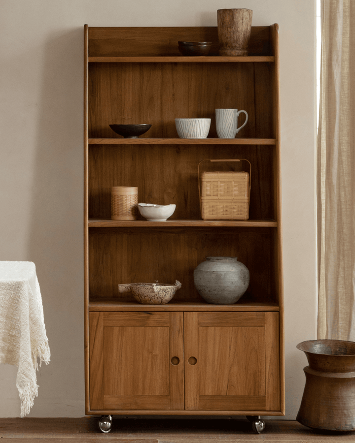 Teak wood display cabinet with open shelves and closed storage, styled with decor items.
