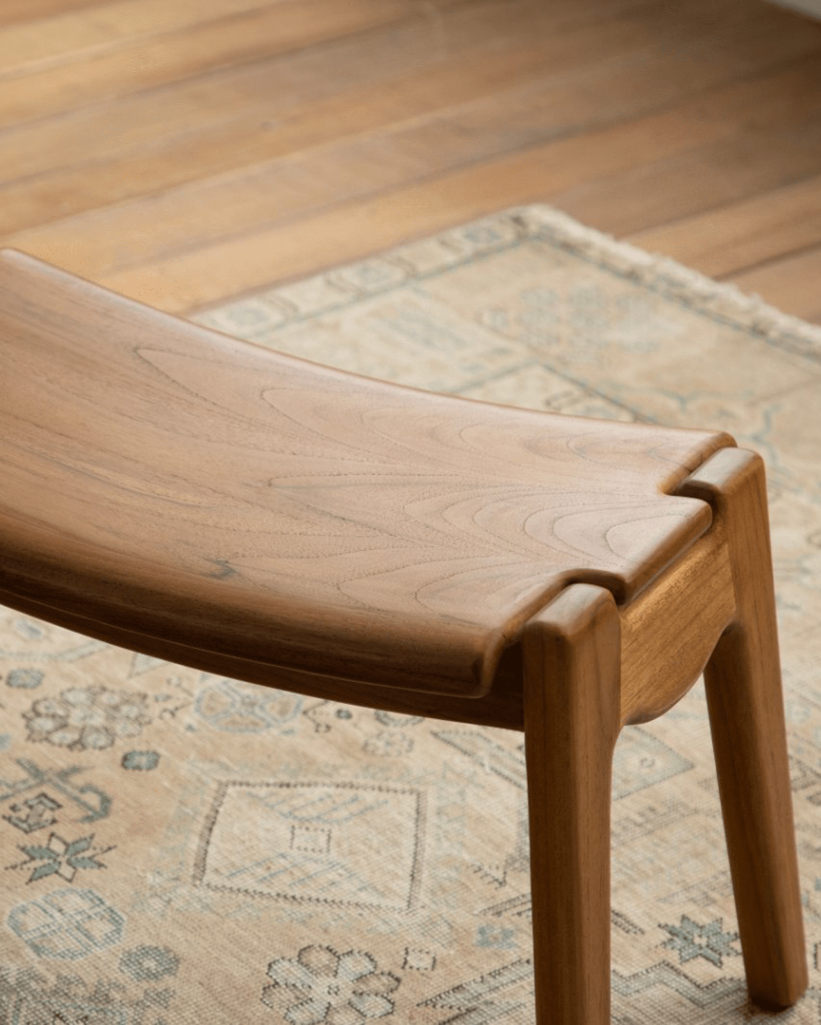 Zen footstool in light brown wood, ergonomic design for relaxation with Zen Armchair. 