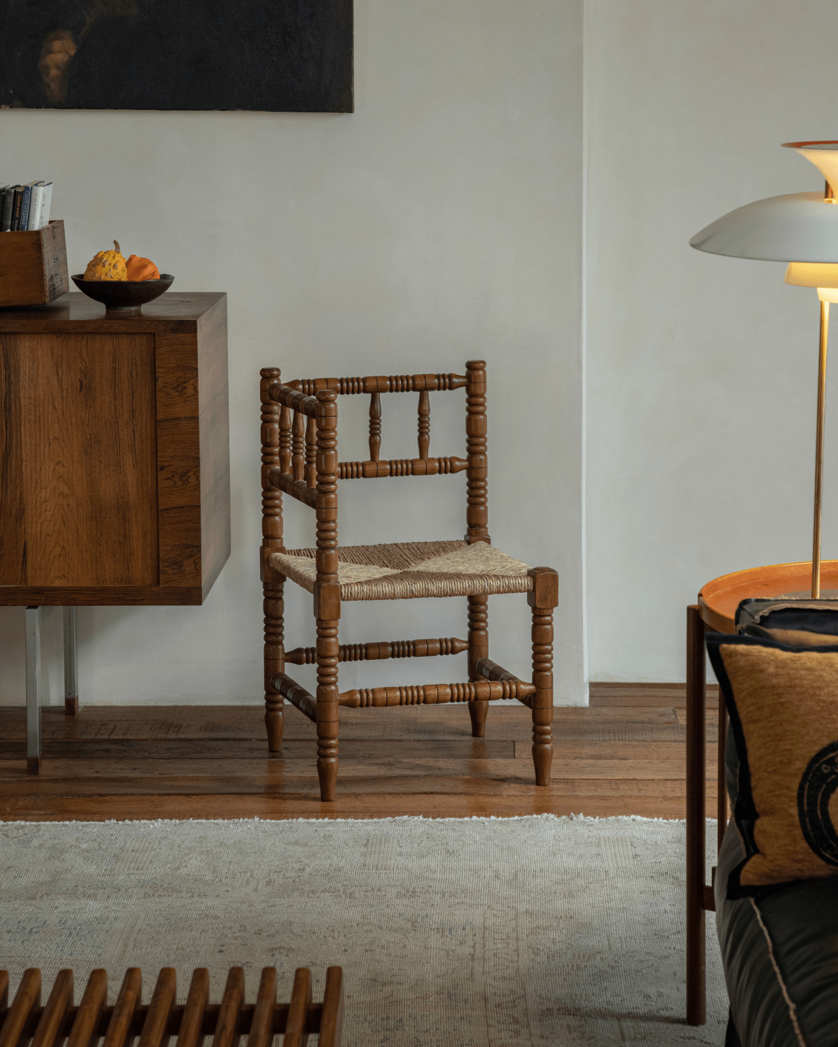 Bobbin Corner Chair - French Vintage design, Indonesian Teak frame, and woven grass rope seat, in a cozy interior.