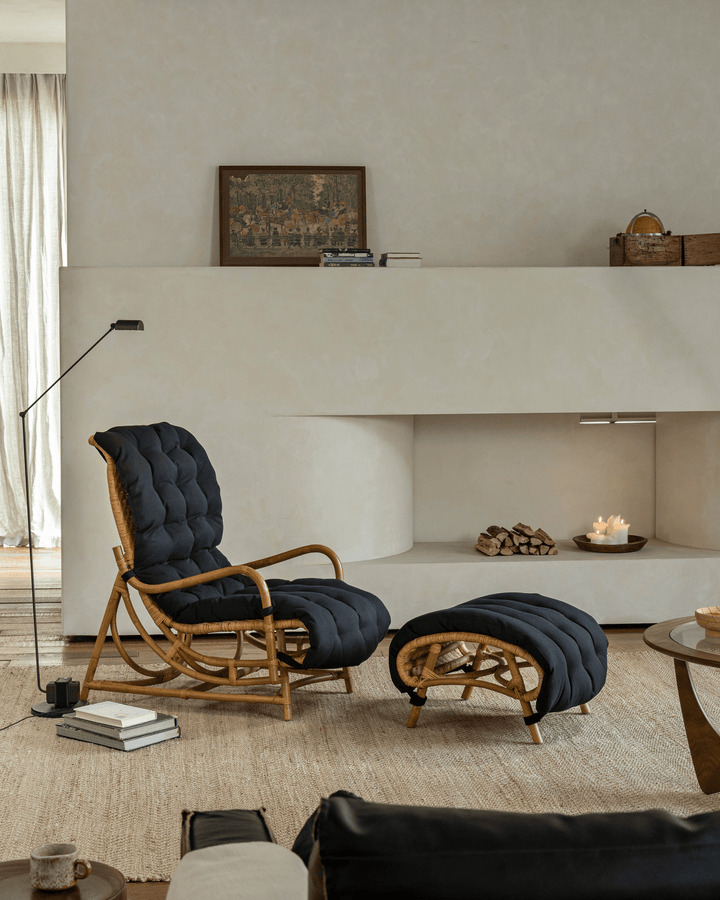 Nalgae rattan lounge chair with black cushion and matching ottoman in a cozy minimalist living room.