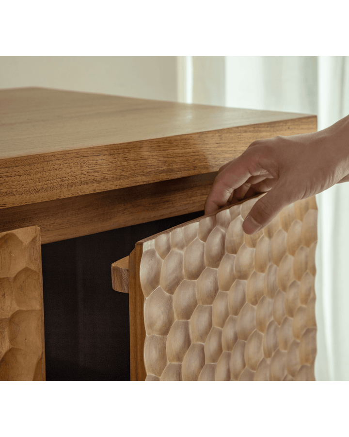 Hand opening honeycomb door of NO.3 Wave Cabinet in a modern vintage interior.