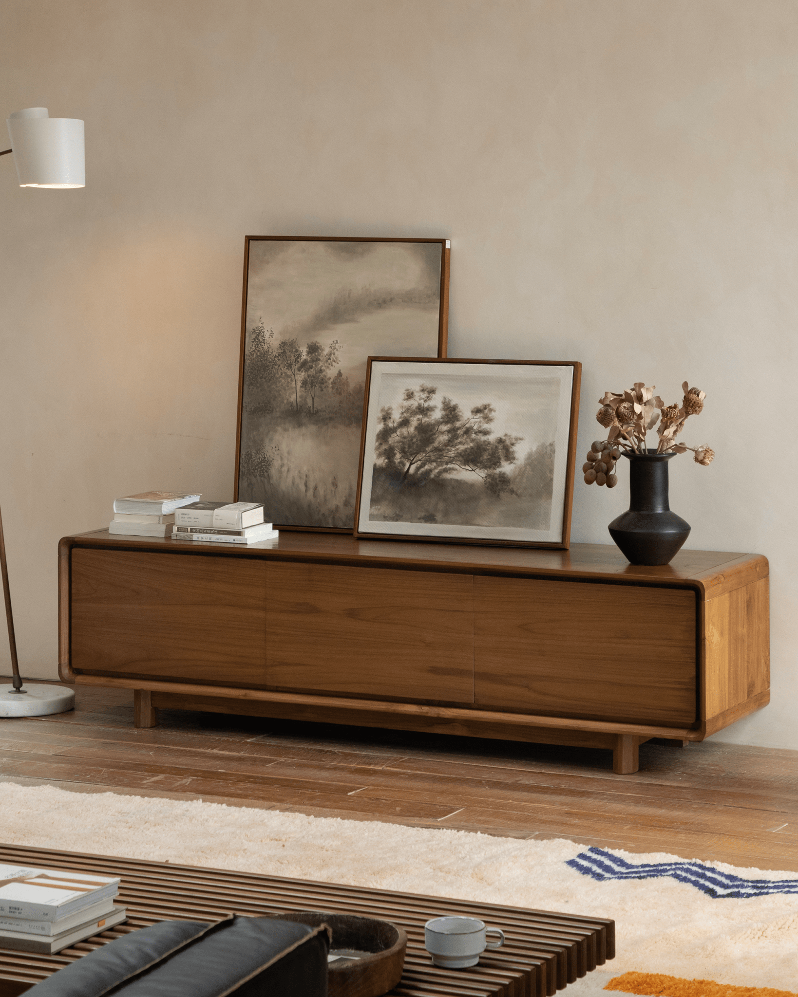NO.34 Media Console in a living room setting with artwork, decorative items, and wooden furniture.