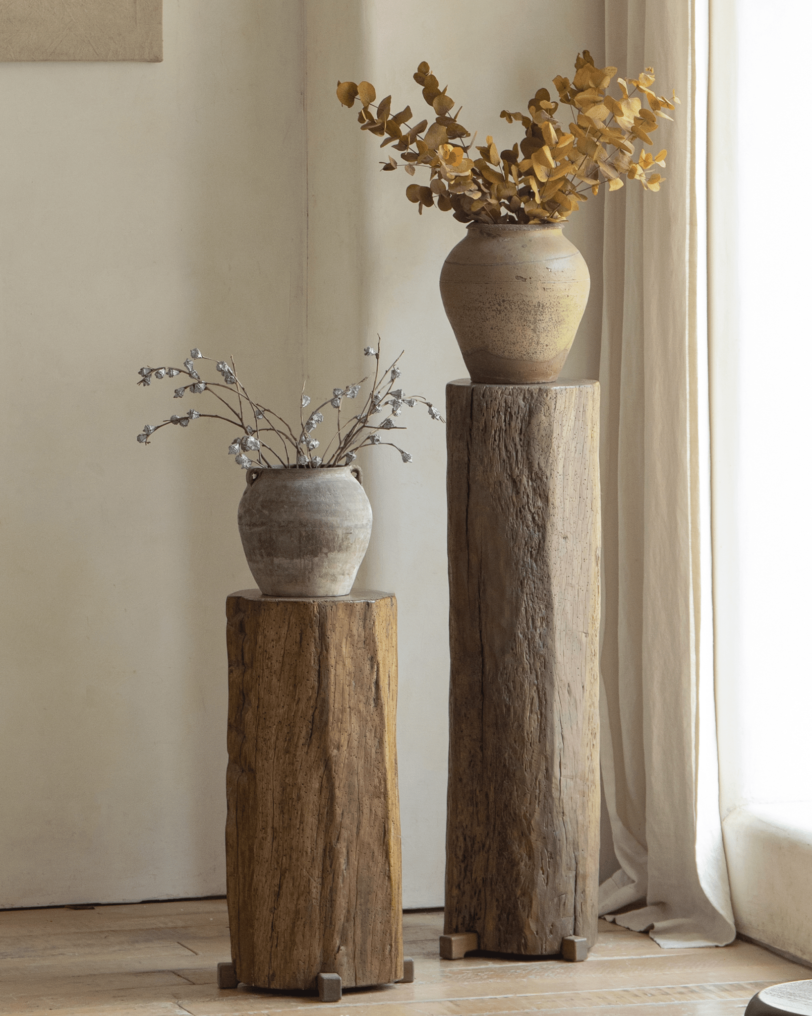 Rustic pedestal display with dried flowers, aged wood and natural textures for organic interior design