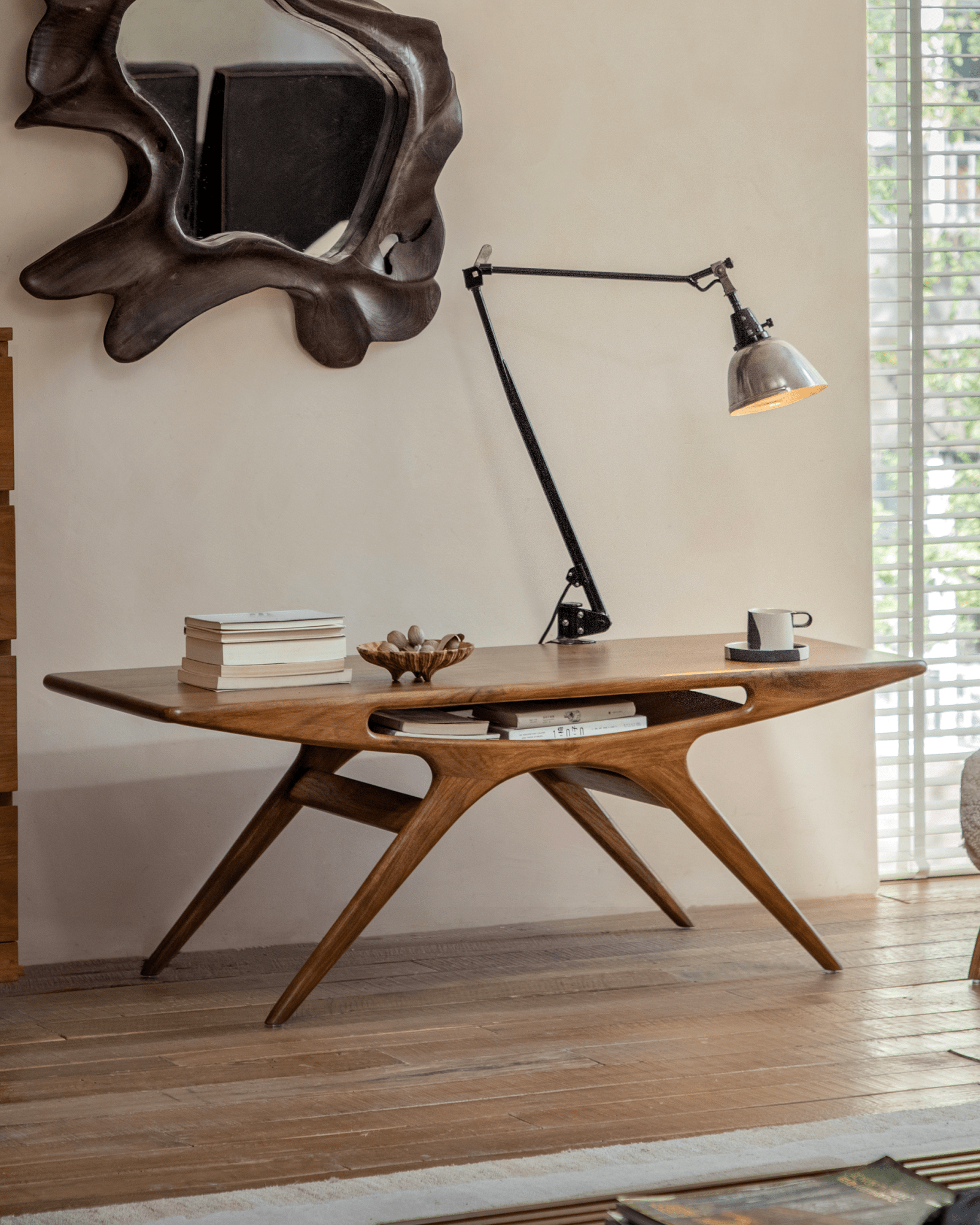 Simile Teak Coffee Table with smile cutout, modern design, displaying books and decorative items, perfect for living room