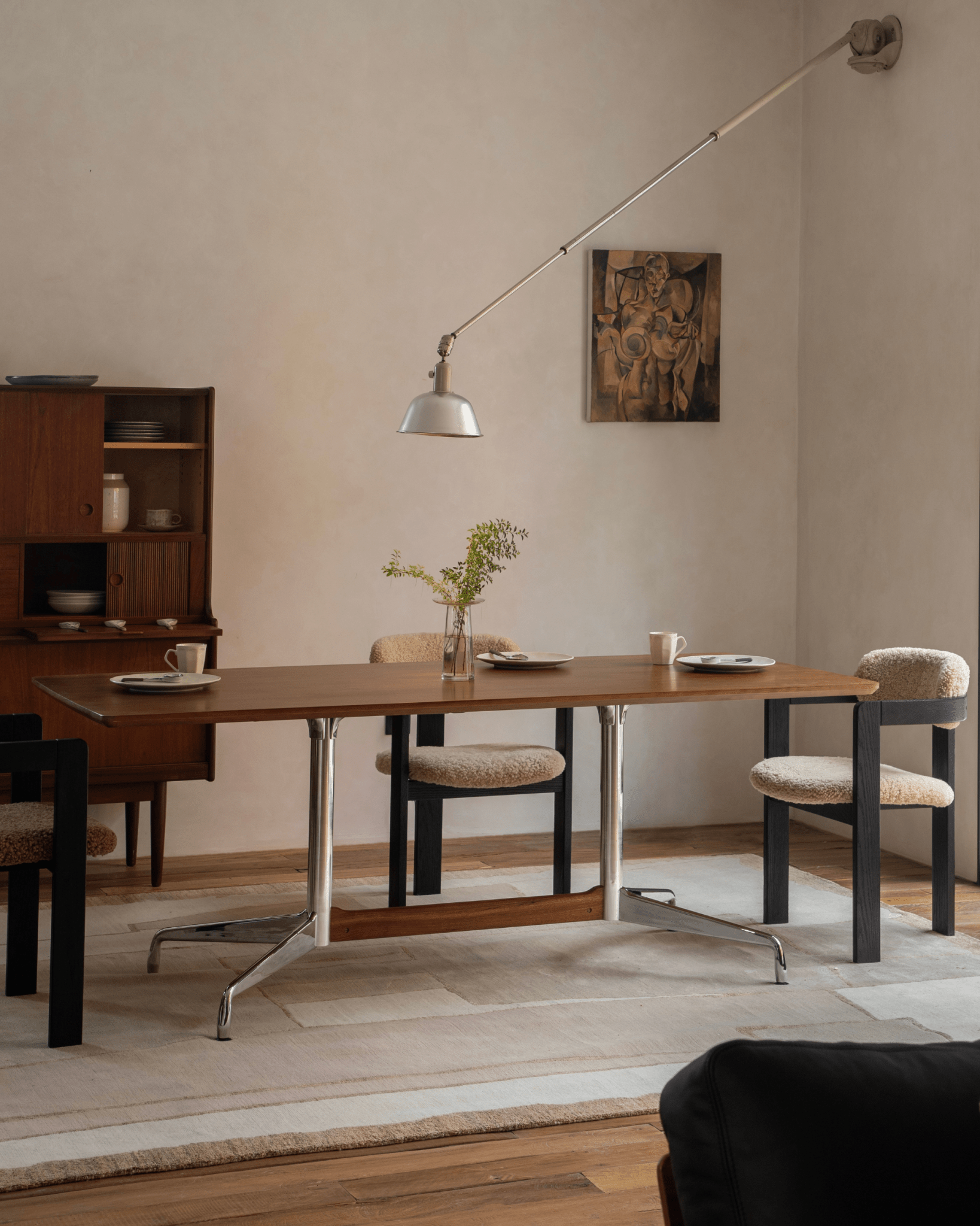 Eames Long Table in dining room with Burmese teak veneer, aluminum legs, and stylish chairs