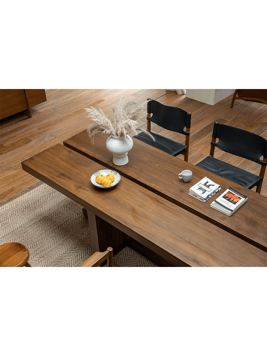 Solid wood sailboat desk in modern interior with elegant decor, natural light, and wooden chairs.
