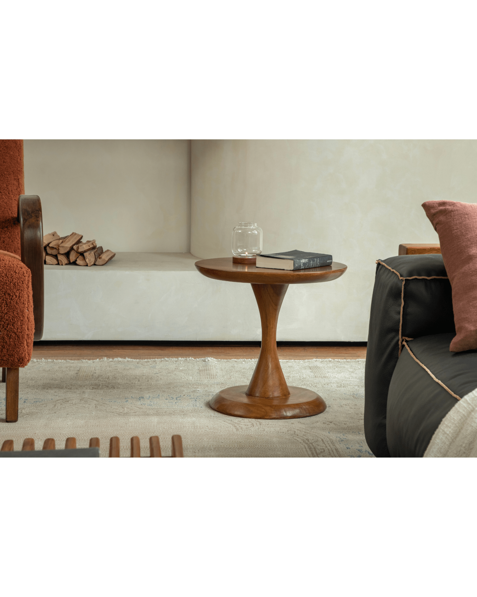 Spindle side table in solid teak wood with hourglass base, holding a book, ideal as a side table