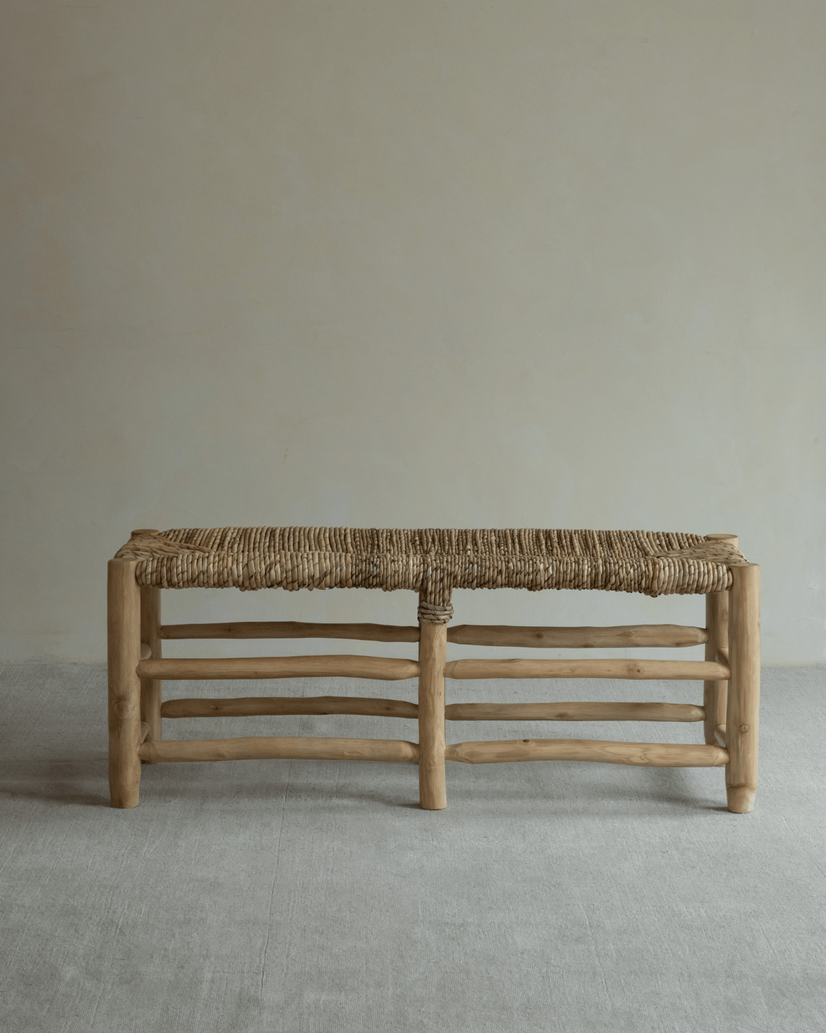 Isla Bench: Modern organic bench with woven pandan leaf seat and solid teak frame.