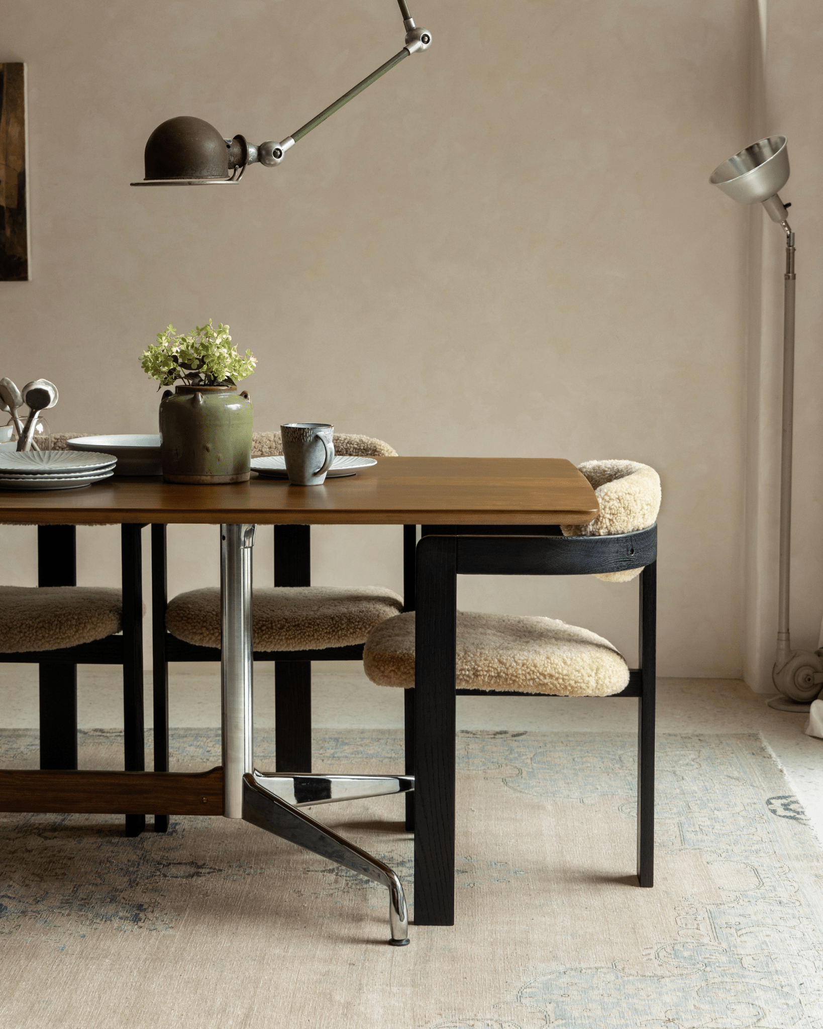 Eames Long Table dining setup with Burmese teak veneer top, stylish chairs, and mid-century modern design.