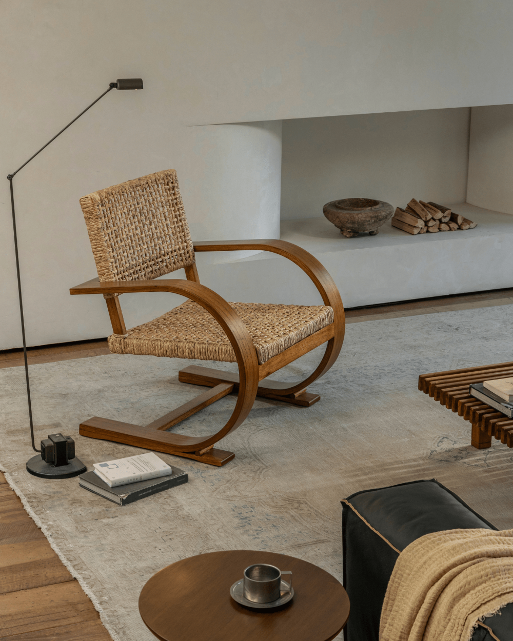 C Curve Lounge Chair with bentwood frame and woven grass rope seat in mid-century modern living room.