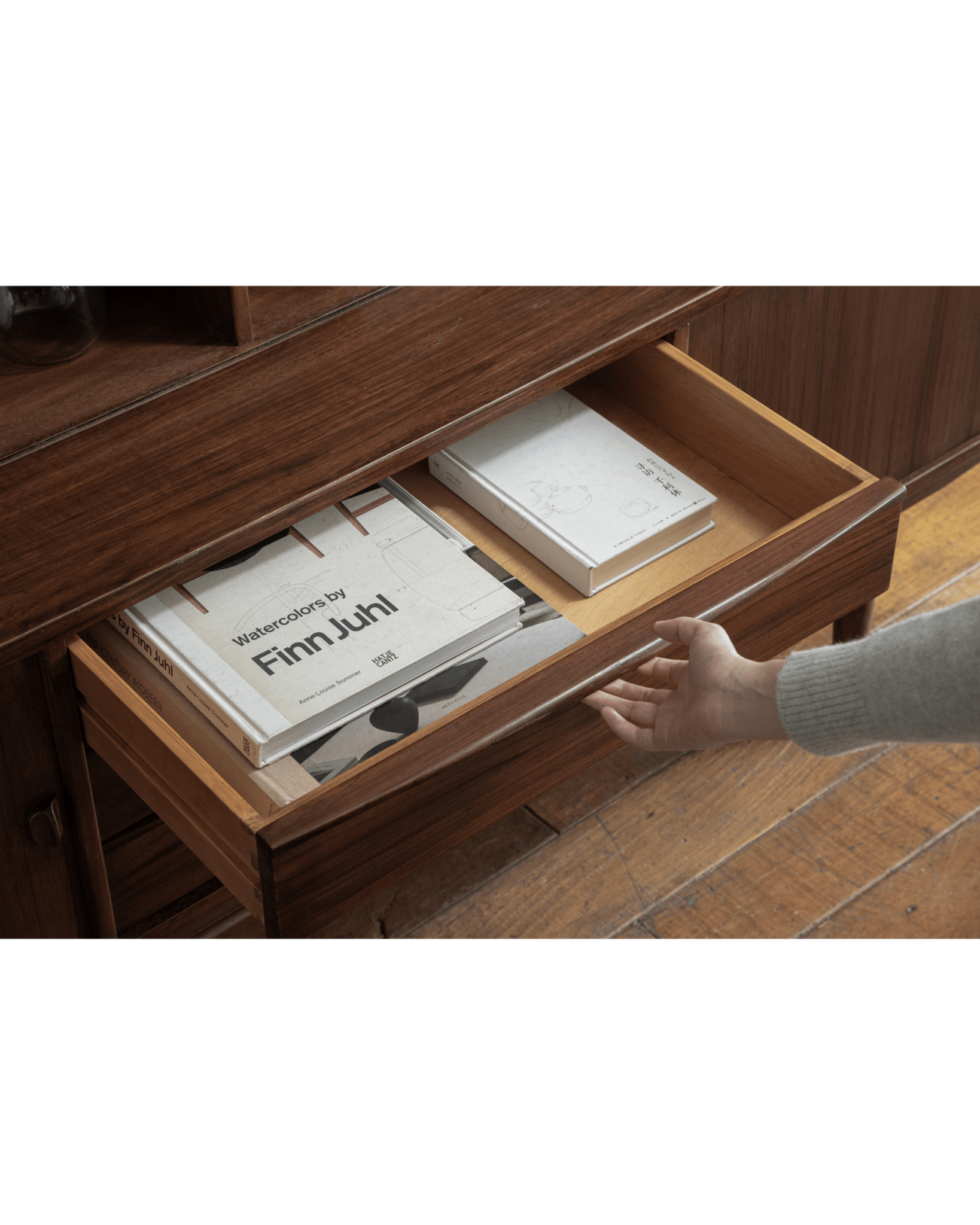 Ibu Teak Sideboard drawer detail with Finn Juhl book, teak wood. Scandinavian mid-century modern design.
