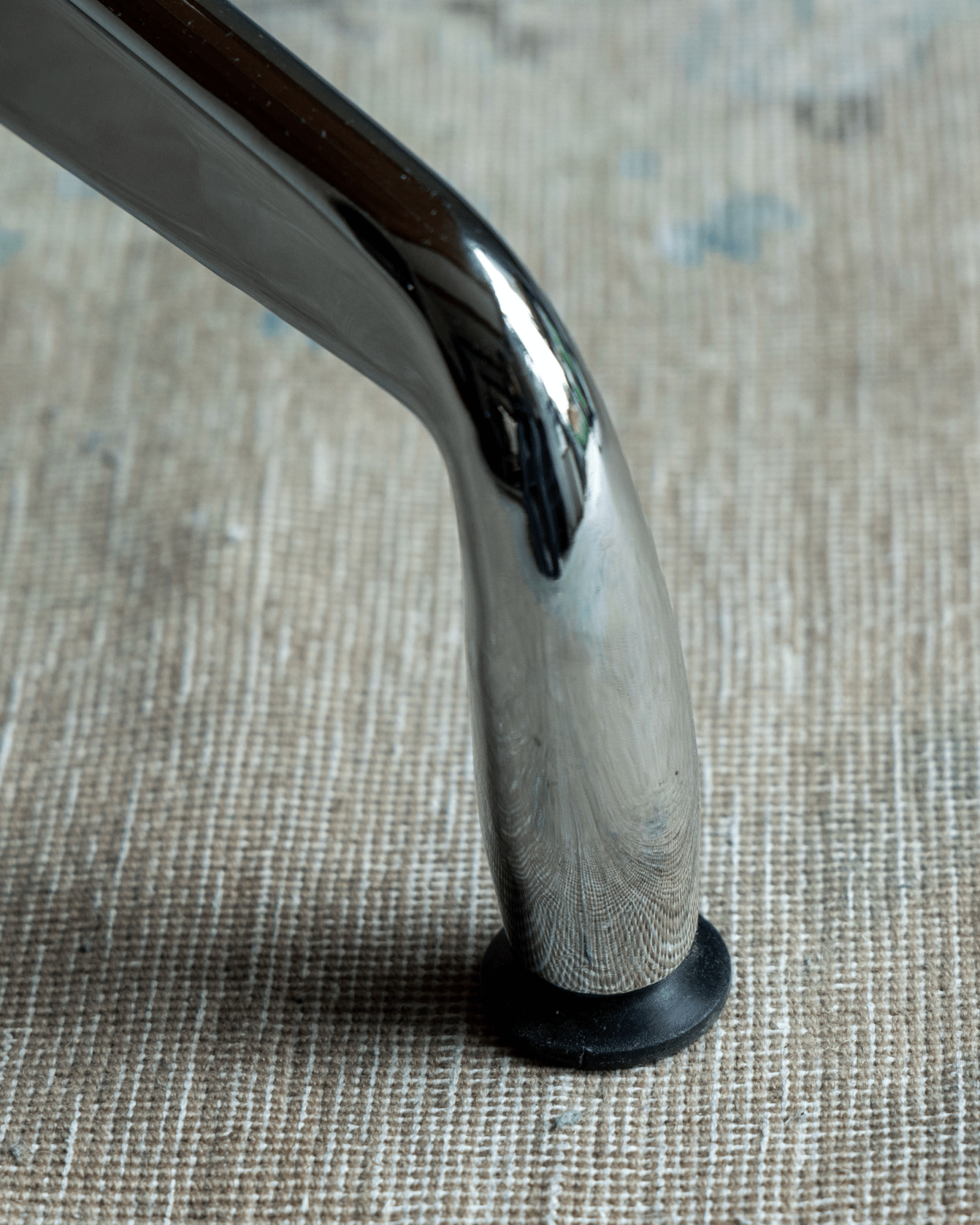 Eames Long Table detail: Chrome aluminum leg, rounded design, mid-century modern aesthetic