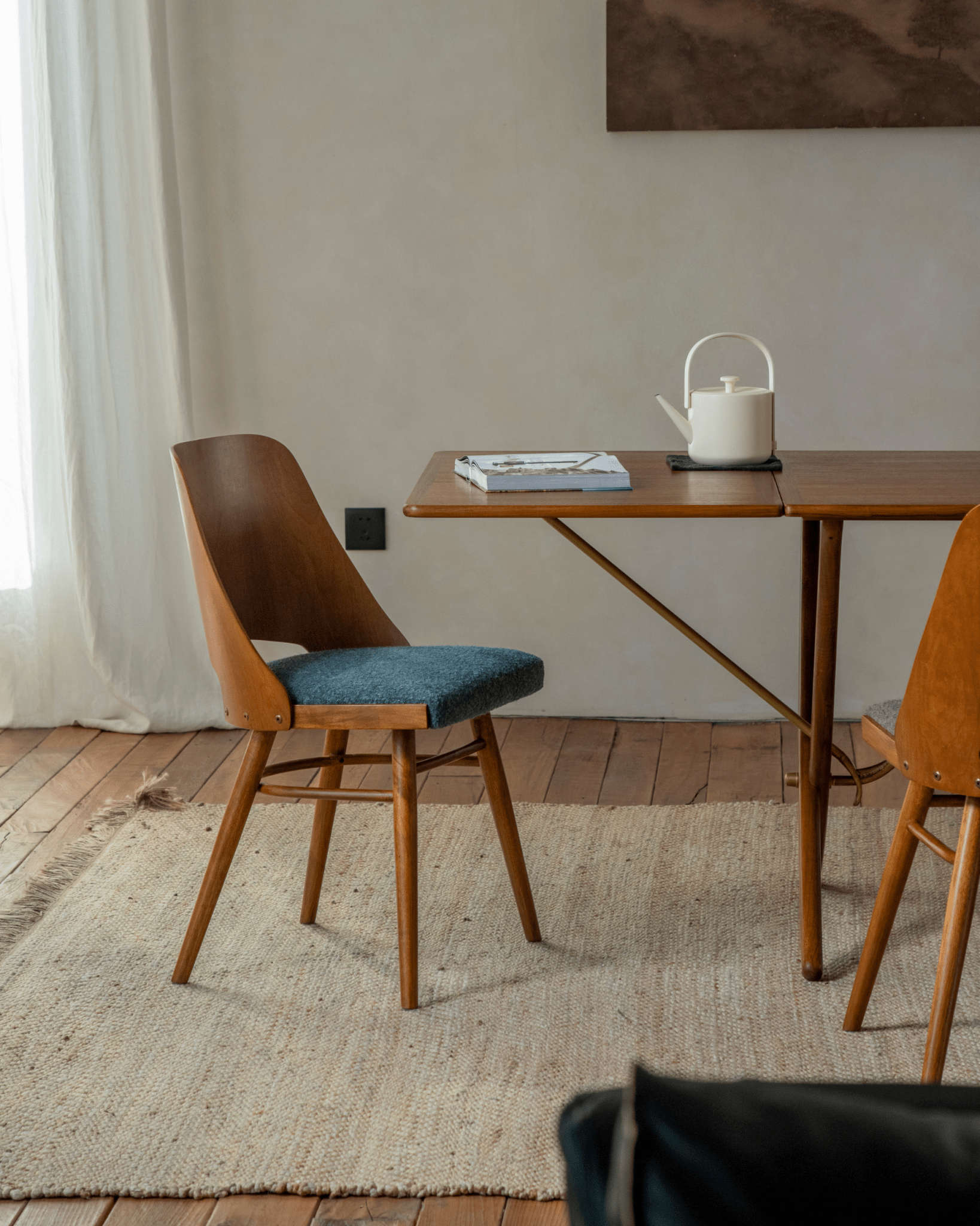 Shell Chair in teak wood with blue fabric seat, vintage design, mid-century modern style.