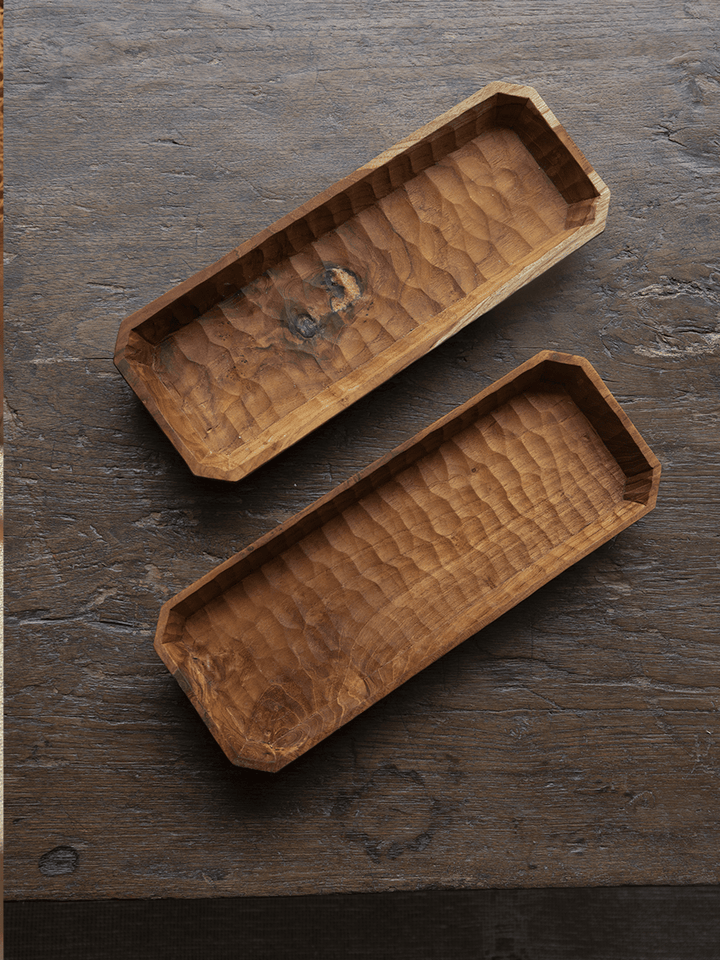 Two handcrafted teak wood rectangular serving trays with textured surfaces.