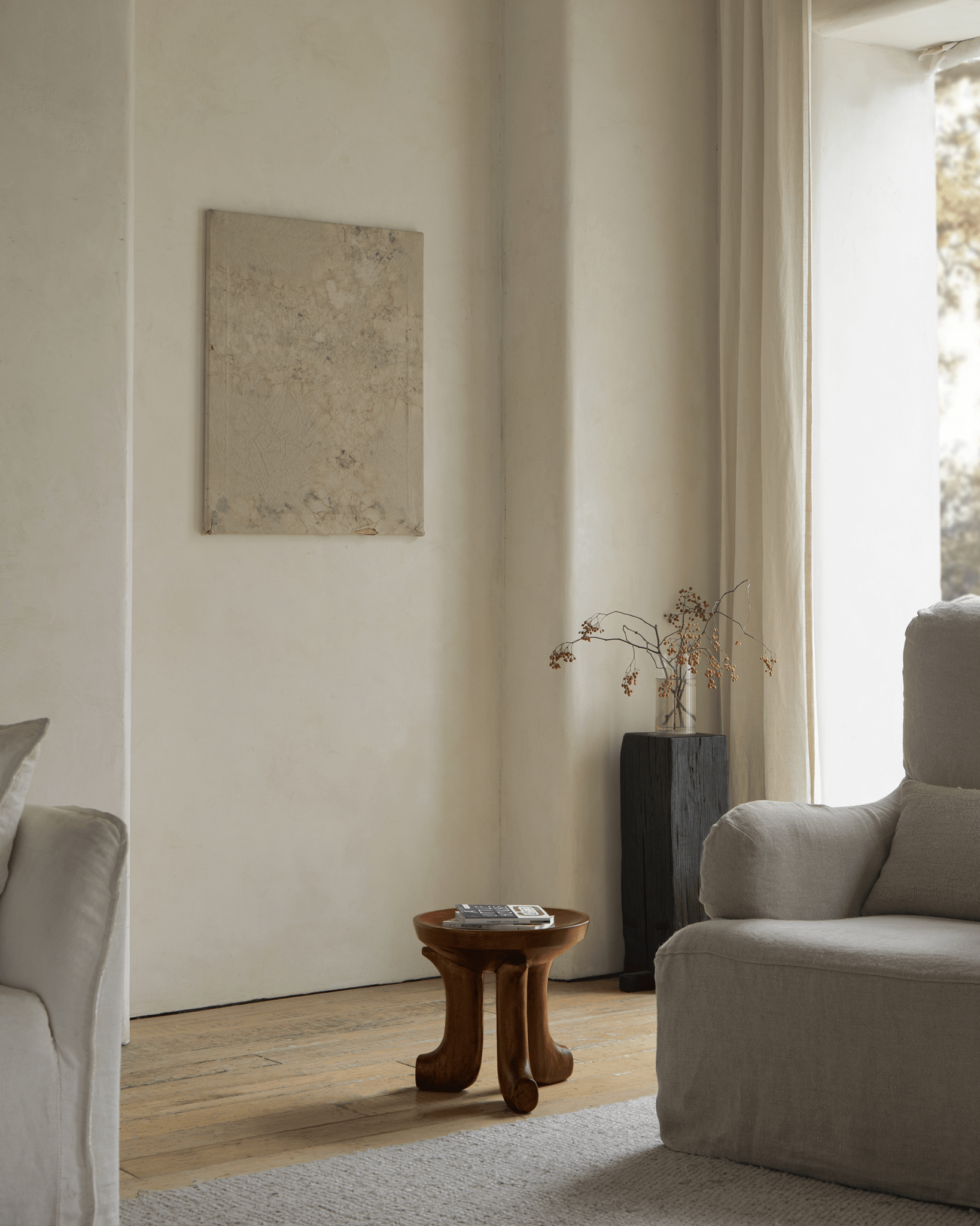 Quincy Stool in a cozy living room, showing solid wood design and natural materials