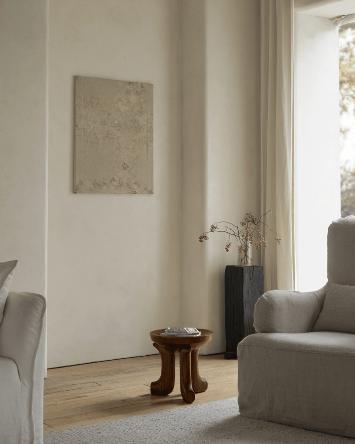 Handcrafted Quincy stool in minimalist living room with natural light and decor.