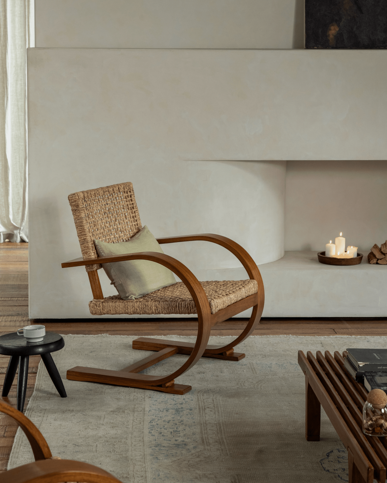 C Curve Lounge Chair in a cozy mid-century modern living room, featuring bentwood frame and woven seat.