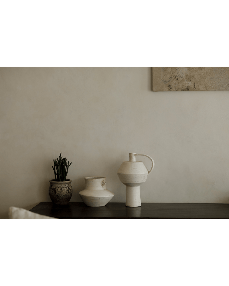 Elegant handcrafted ceramic vases on a wooden table, showcasing minimalist design.