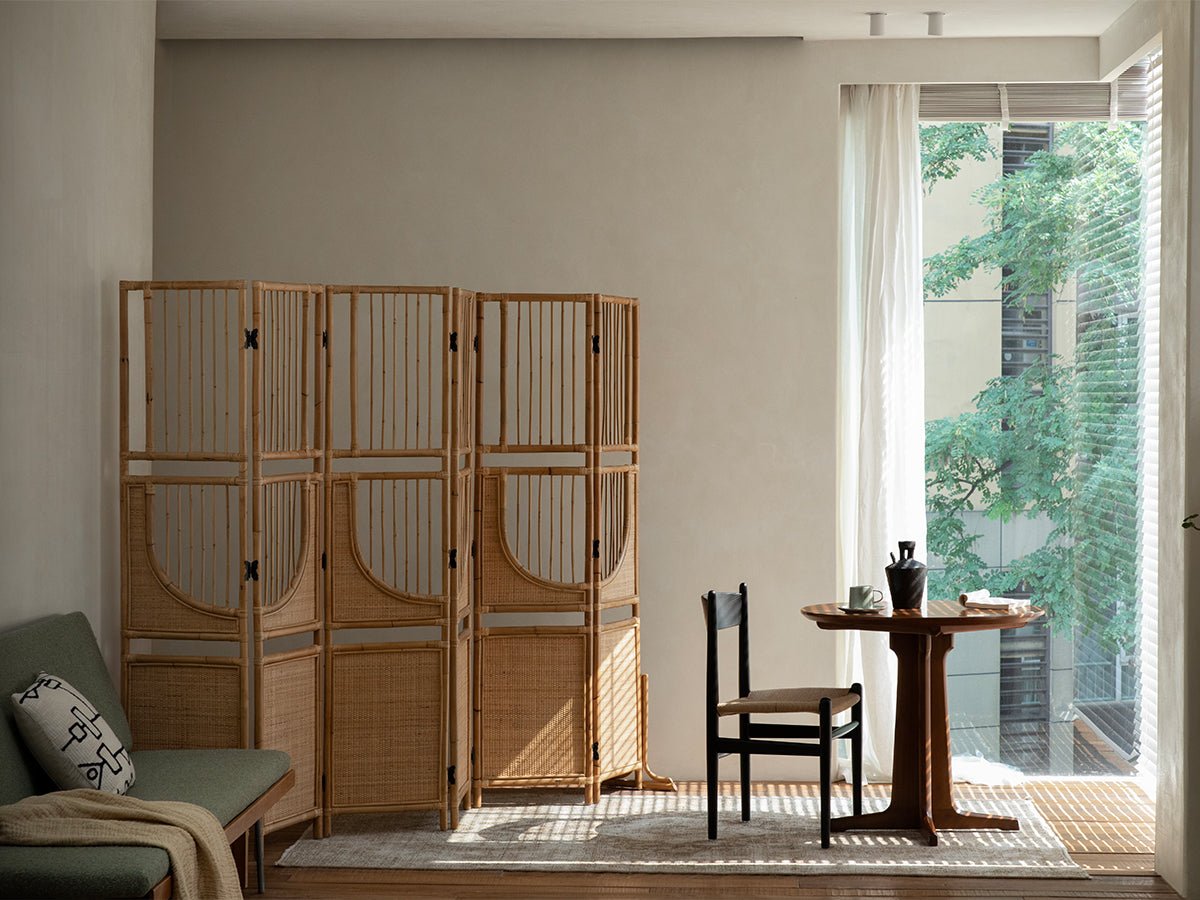 Indonesian rattan Sunlit Screen, room divider in natural light, with minimalist interior design.