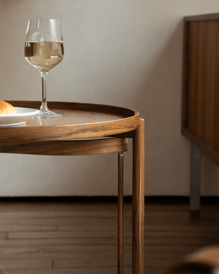 Hansen Tray Side Table with wine glass and croissant in modern living space.