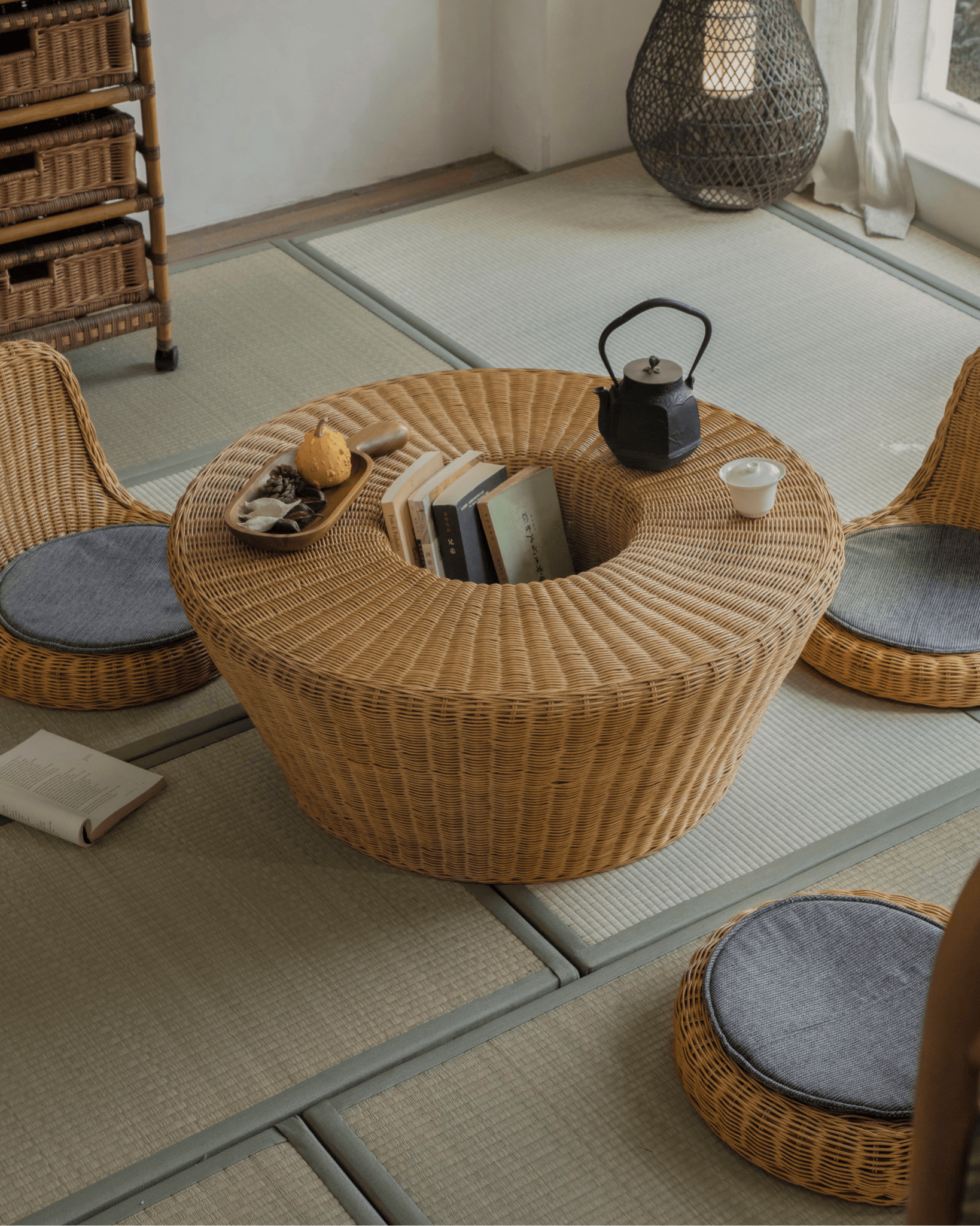 Nest Coffee Table in a living room setting with woven rattan design, showcasing sunken storage and matching rattan chairs.