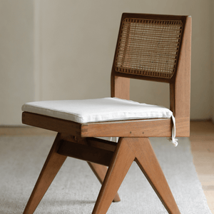 Chandigarh armless office chair with teak wood frame, rattan backrest, and white linen cushion