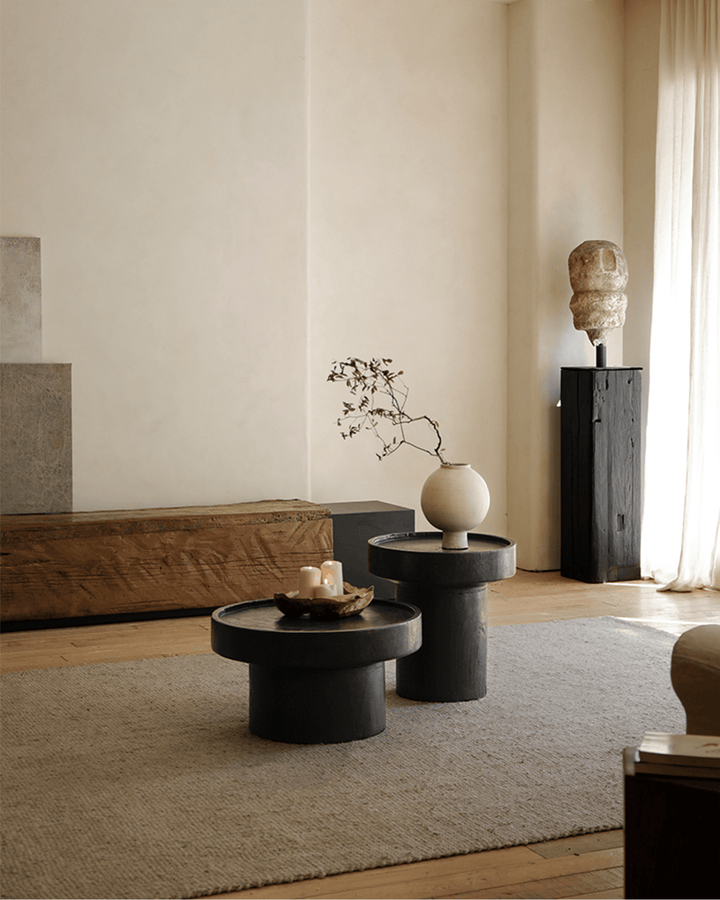 Stylish black Stamp Coffee Tables with decorative vase and candle arrangement.