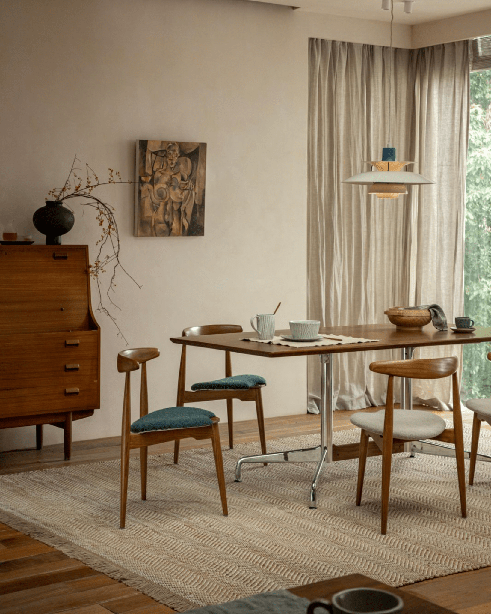 Heart Dining Chair showcasing Danish design with wooden frame and teal seat in a vintage-style room.