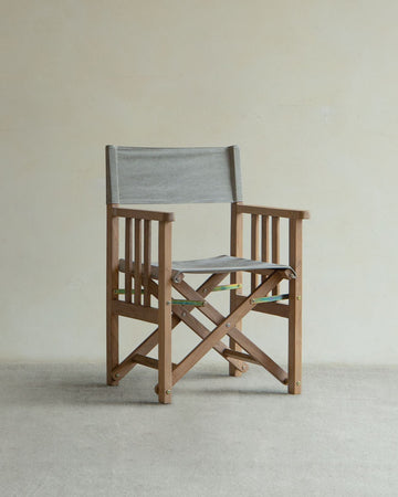 Folding director chair with teak wood frame and gray canvas seat and backrest
