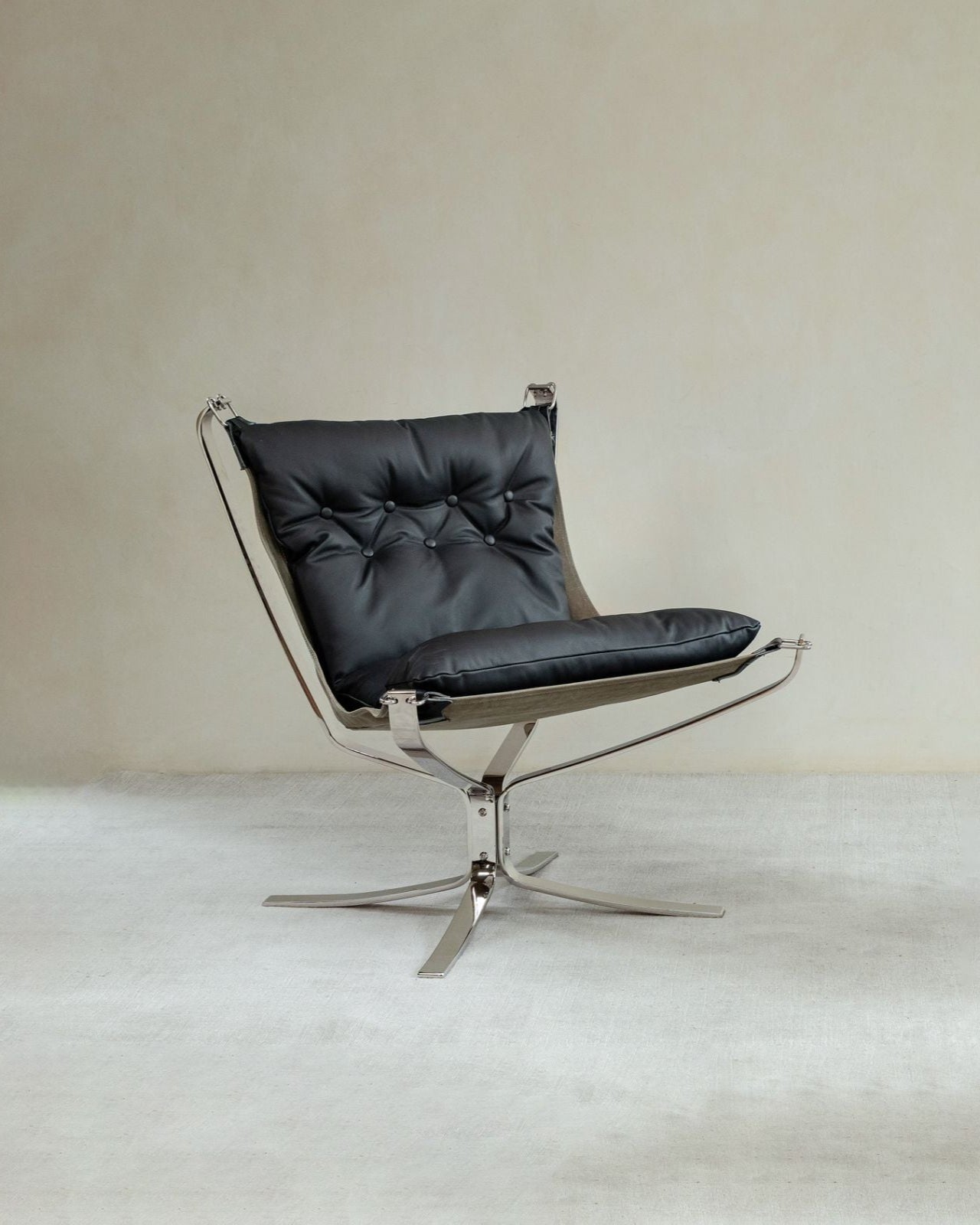 Falcon Chair in black leather with brushed stainless steel frame, Scandinavian design