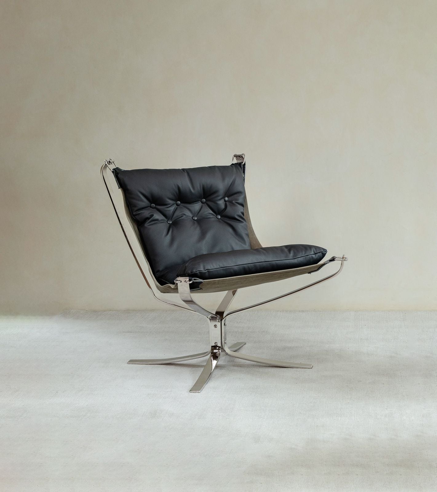 Falcon Chair in black leather with brushed stainless steel frame, Scandinavian design