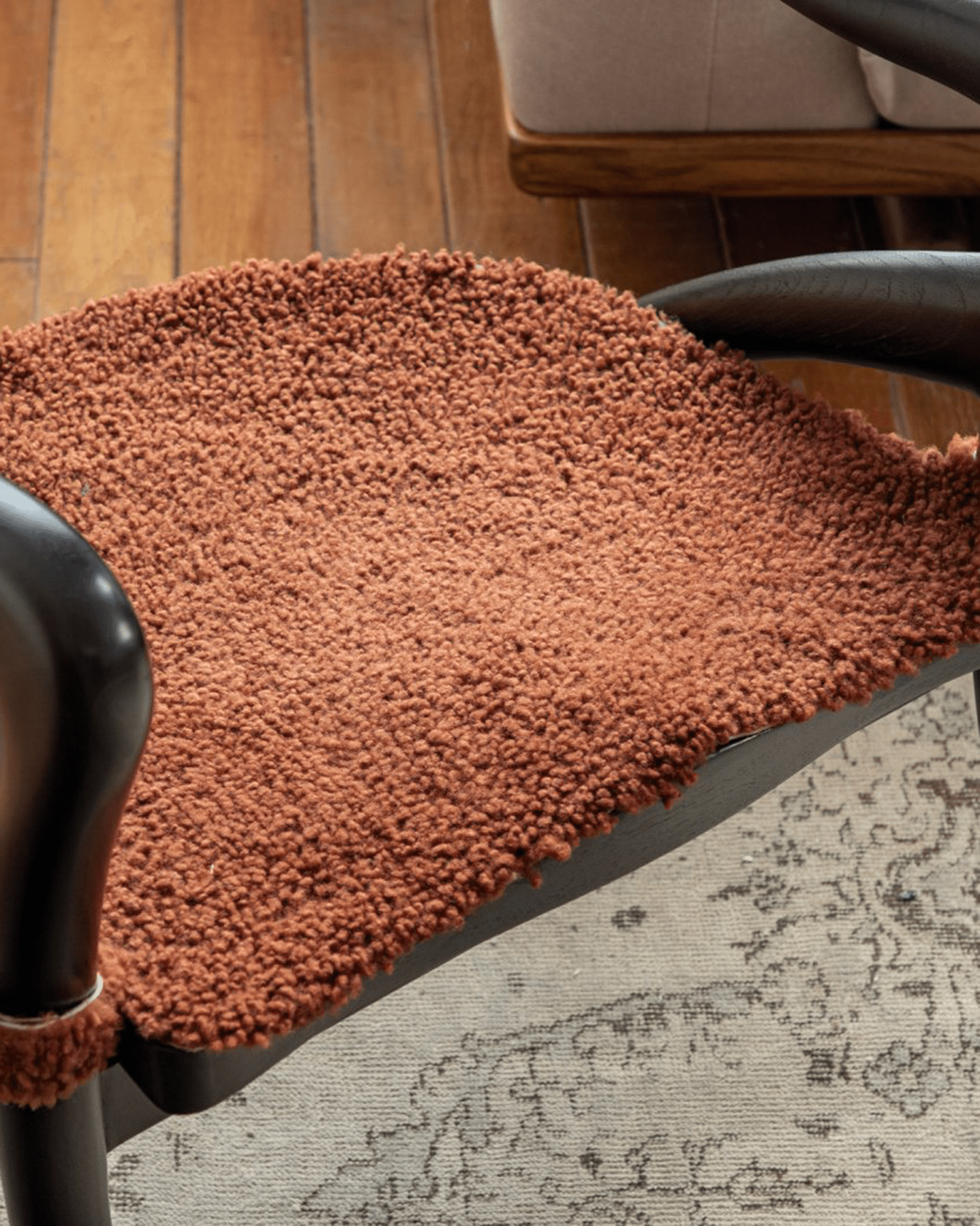 Olivia Chair seat cushion with textured fabric, modern design, curved backrest, and teak wood frame.