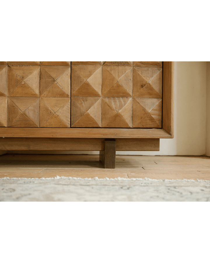 Geometric wooden pattern on Bumpy Sideboard in bright interior.