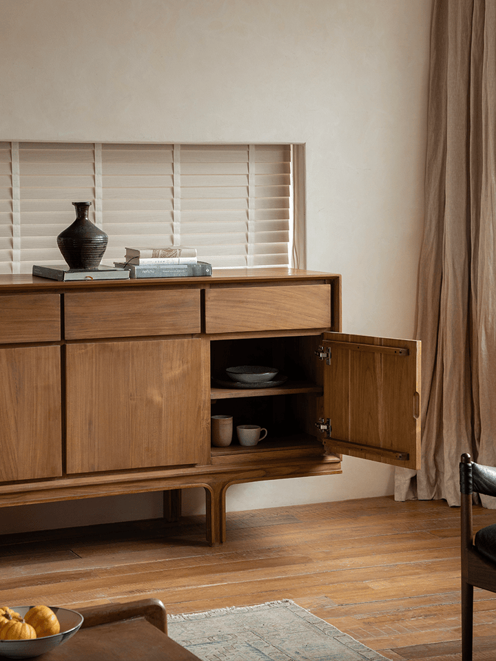 NO.44 teak sideboard with open door showcasing storage and decor in a warm living space.