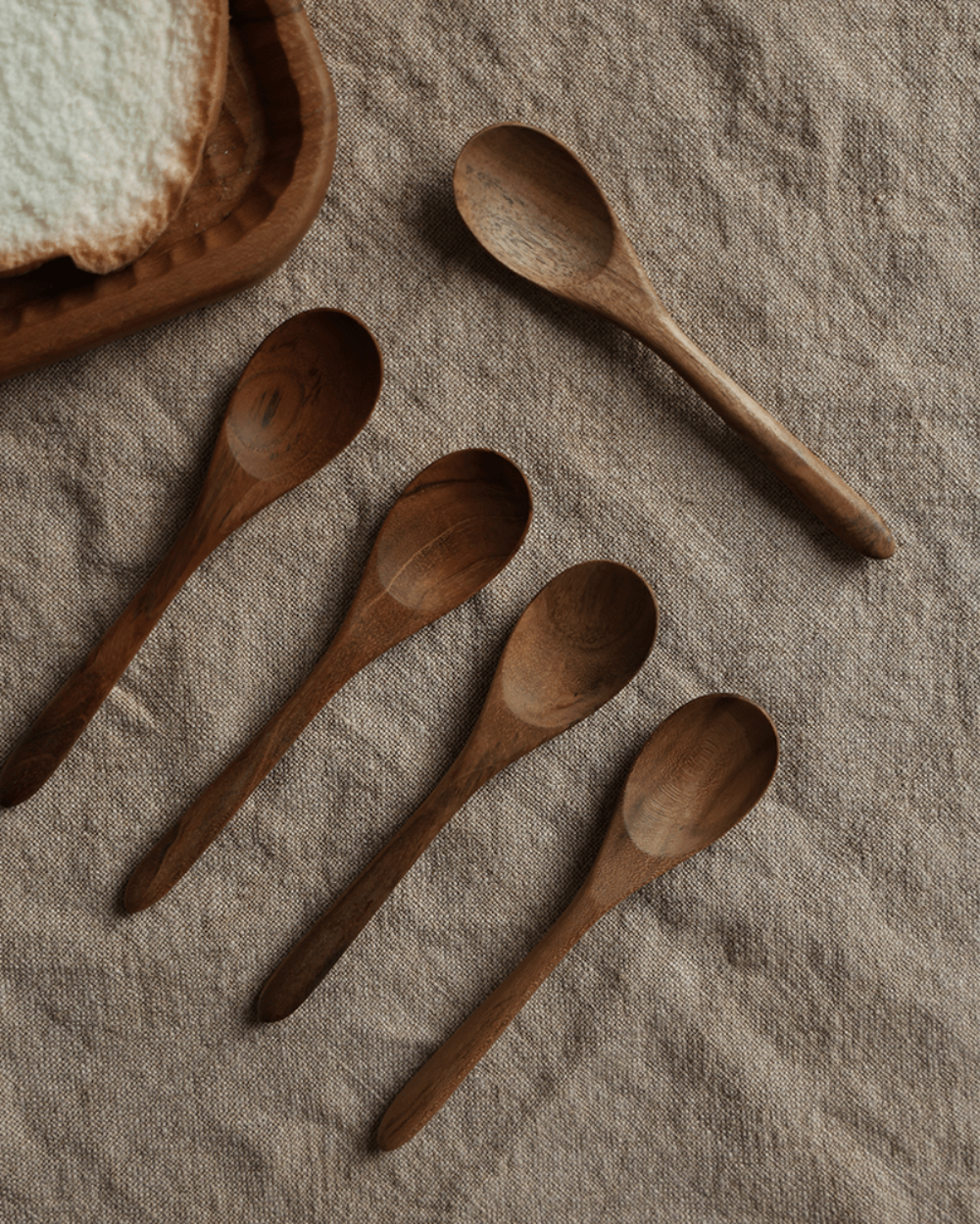 Set of five wooden table spoons on beige linen. Natural wood finish, product shot. Table Spoon*4PCS.
