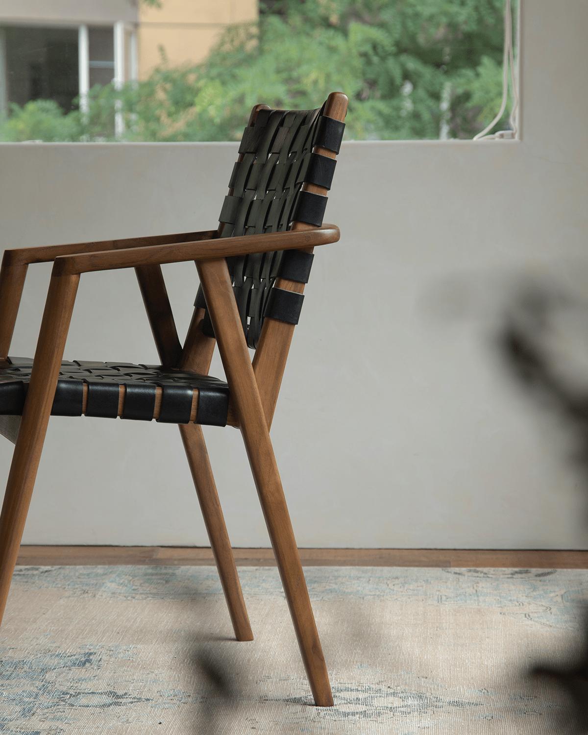 Louisa Chair, Mid-Century Modern design with teak frame and black leather woven seat, perfect for study or dining room.