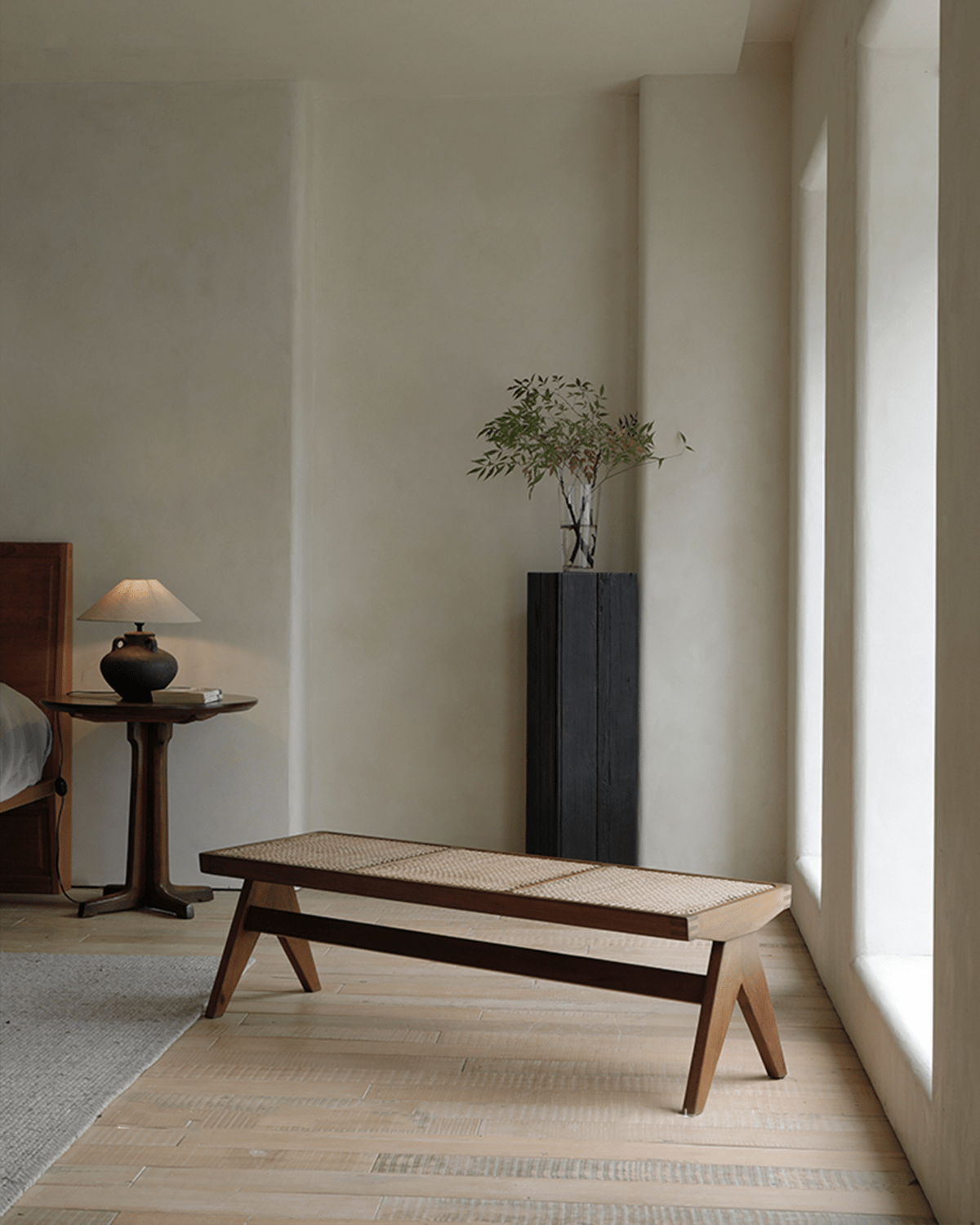 Chandigarh Bench in bedroom setting, teak wood frame and natural rattan seat