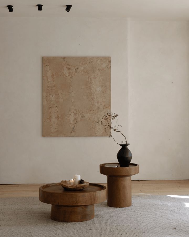 Stylish Stamp Coffee Table with a decorative vase and candle on a minimalist backdrop.