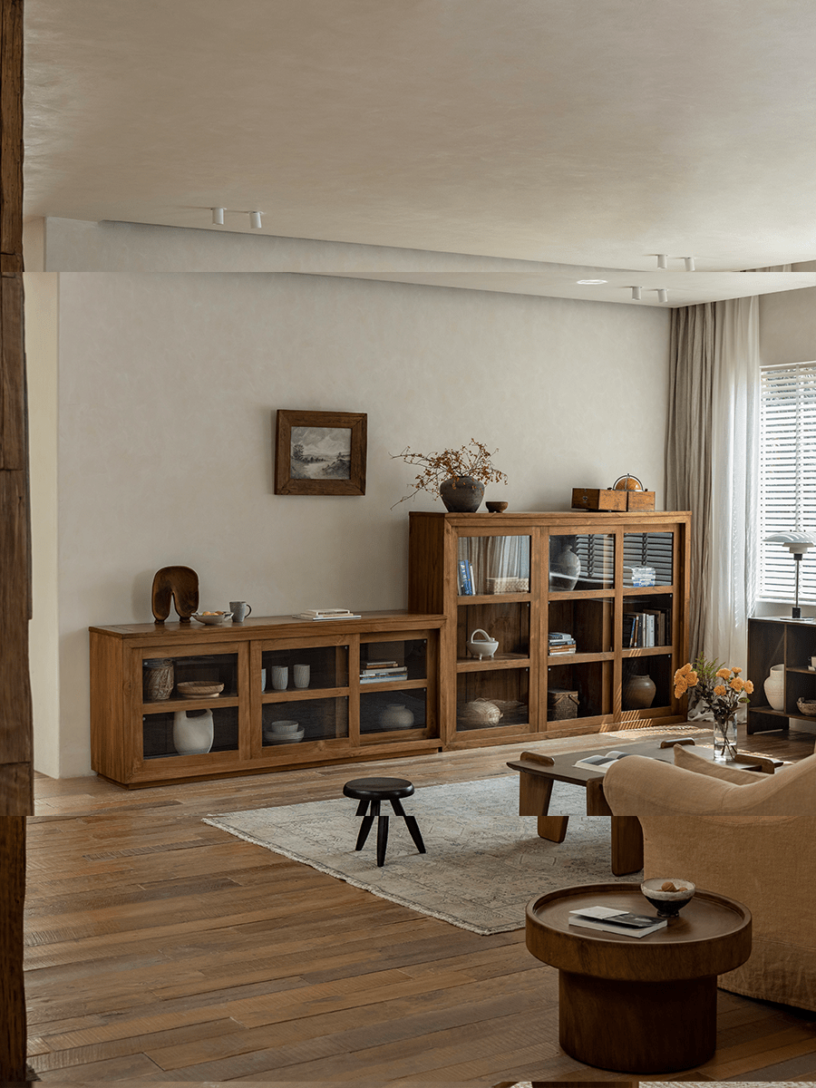 Teak wood glass front bookcase in a stylish living room setting, perfect for display and storage.