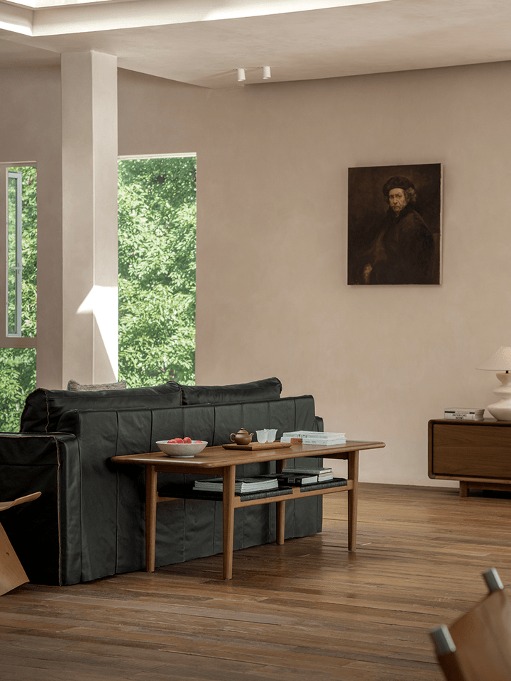 Wooden accent table in modern living room with natural light and green view.