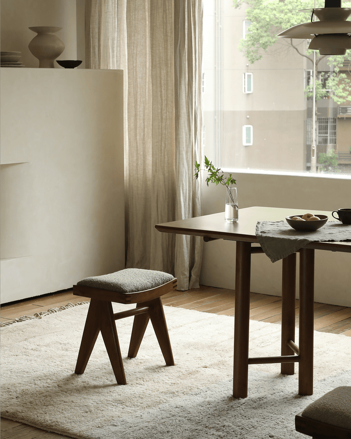 Chandigarh Easy Stool with green seat in a modern dining room setting