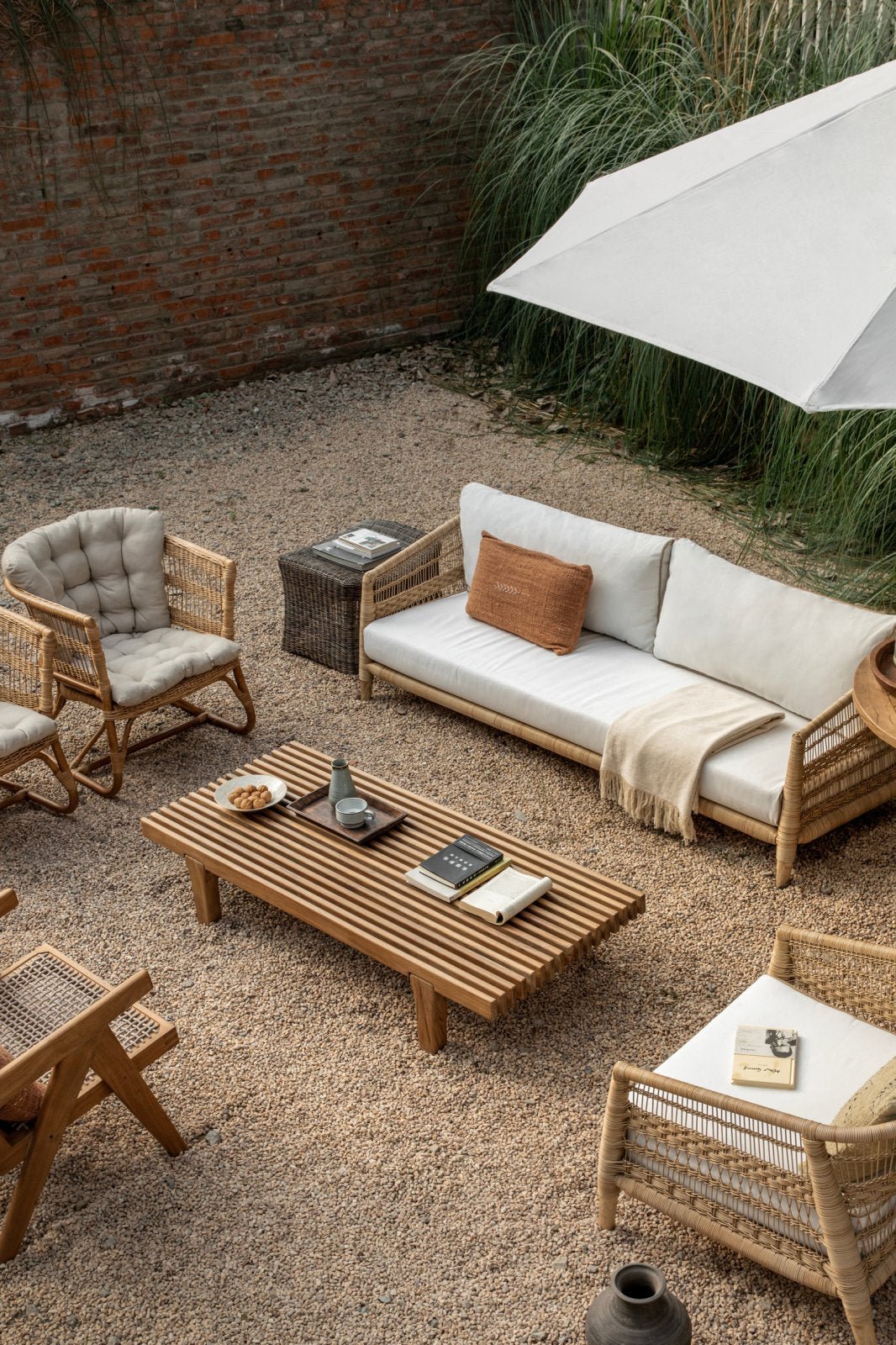 ZM Daybed Coffee Table in outdoor setting with rattan furniture and teak wood table